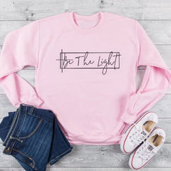 Unisex Christian Sweatshirt: Featuring 'Be The Light' motif.